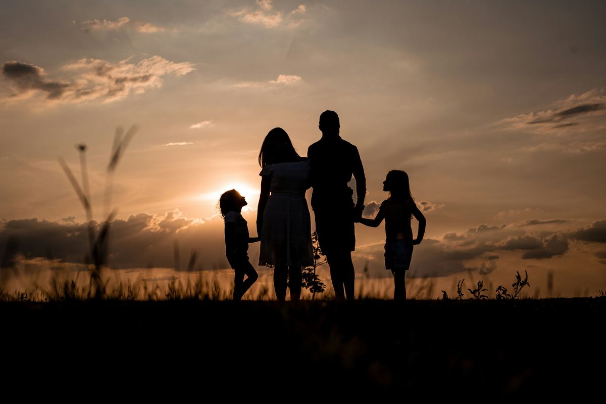 Family looking ahead together at sunset